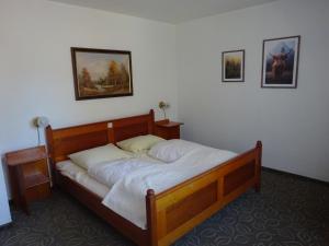 a bedroom with a wooden bed in a room at Schloß-Hotel Hirschau in Hirschau