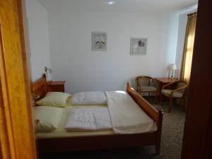 a bedroom with two beds and a table and chairs at Schloß-Hotel Hirschau in Hirschau