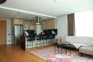 a living room with a couch and a bar at Deluxe 2BR Apartment Balcony 420 in Istanbul