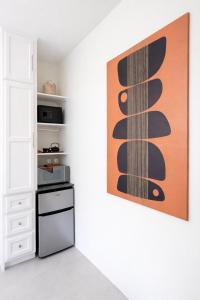 a kitchen with a painting on the wall at Rivers End Guesthouse in Hope Bay