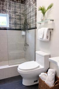 a bathroom with a shower and a toilet and a sink at Rivers End Guesthouse in Hope Bay