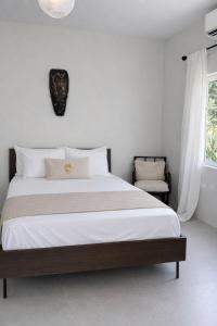 a bedroom with a large bed with white sheets at Rivers End Guesthouse in Hope Bay