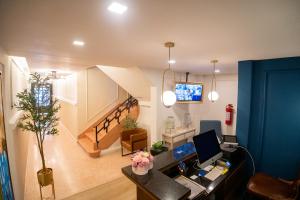an office with a desk with a computer and a staircase at Priede Hotel Boutique in Puebla