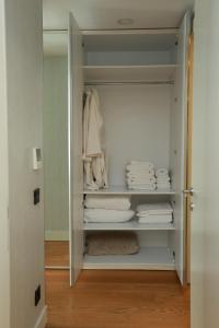 a walk in closet with white clothes and towels at Deluxe 2BR Apartment Balcony 420 in Istanbul +44 photos