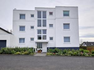 a white building with a lot of windows at ARGENTA Living 129 in Künzell