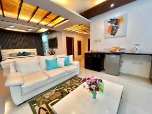 a living room with a white couch and a table at private villa with private pool in Aborlan