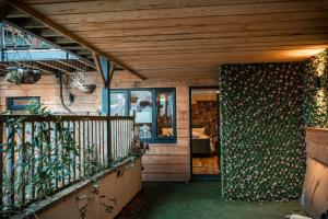 a house with a wooden ceiling and a balcony at The Wellsprings Lodges and Restaurant in Clitheroe