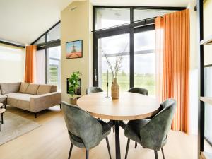 a living room with a wooden table and chairs at Bollen in Oud-Ade +15 photos
