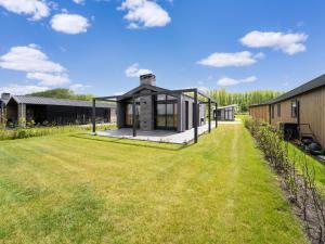 a house with a large yard next to a building at Bollen in Oud-Ade