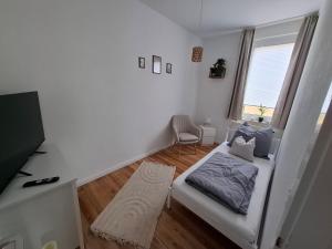 a living room with a white couch and a window at Wohnung HoMe No 17 in Parchim