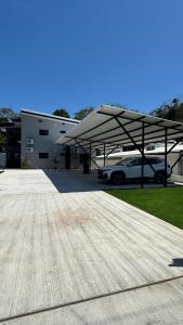 a car garage with a car parked under a canopy at Riverside Apartments in Jacó