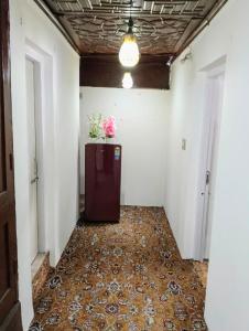 a hallway of an office building with a refrigerator with flowers on it at The Holt Gardens in Srinagar
