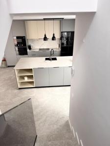 a kitchen with white cabinets and a sink at Casa Benicasim in Benicàssim