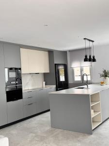 a kitchen with white cabinets and a white counter top at Casa Benicasim in Benicàssim
