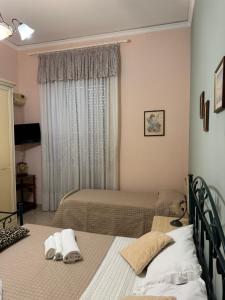 a bedroom with two beds and a window at Casa del Corso Apartments in Avola