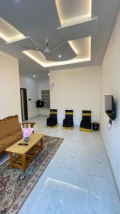 a living room with a couch and a table at Halfmoon Homestay in Kalyānpur +24 photos