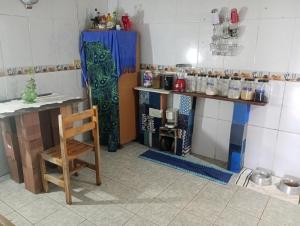a kitchen with a table and a chair in a room at há uma bela casa in Ubatuba