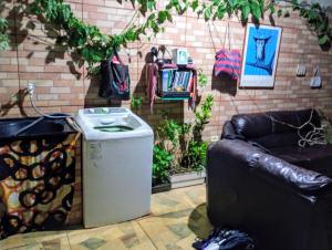 a trash can sitting next to a leather couch at há uma bela casa in Ubatuba