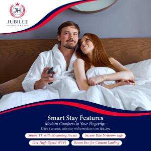 a man and a woman laying in bed at Jubilee Hotel Kensington in London +125 photos