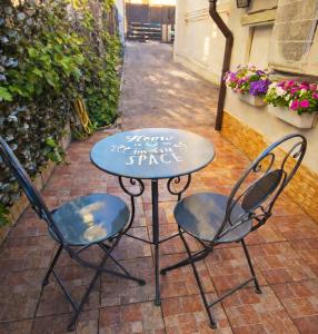 a table and two chairs on a patio at Casina Appia Antica in Marino