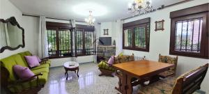 a living room with a table and some chairs at Villa Teresa - Casa familiar con jardín en Cangas de Onís in Cangas de Onís