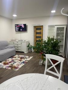 a living room with a couch and a tv on the wall at La casa di Elena in Reni