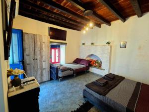 a bedroom with a bed and a couch in a room at Symi Blue Studio in Symi