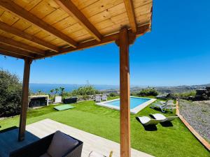 a view from the patio of a house with a swimming pool at Villa Alegría Gran Canaria Piscina Climatizada in Las Palmas de Gran Canaria