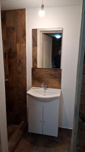 a bathroom with a white sink and a mirror at Casa B&P in Costinesti +7 photos