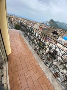 a balcony with a iron fence and a view of a city at Karina in Carini