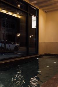 a pool of water in front of a building at Lavena Boutique Hotel in Sầm Sơn