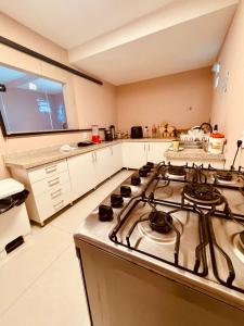 a kitchen with a stove top oven in a kitchen at Villa Mar - Baia Formosa in Baía Formosa