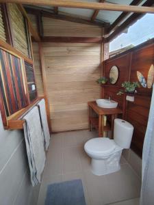 a bathroom with a toilet and a sink at cabaña malambo in Termales - agua caliente - nuqui +22 photos