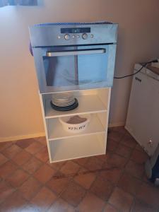 a kitchen with a blue stove and white drawers at Slettavegen1a in Time