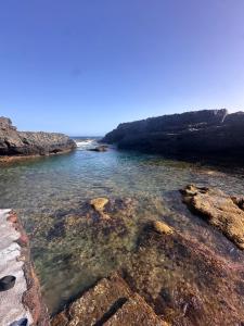 a body of water with rocks in the water at Casa El Sato in Echedo