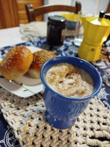 a blue cup of coffee next to a plate of bagels at Almyra traditional residence in Andros