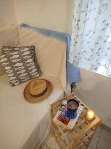 a hat sitting on a couch with a basket on it at Almyra traditional residence in Andros