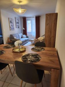 a living room with a wooden table with chairs at Le petit marché de Sainte Cécile- Centre historique Albi in Albi