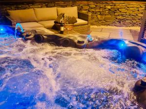 a jacuzzi tub in a room with a couch at The Steading in Dumfries