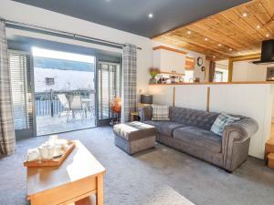 a living room with a couch and a table at The Steading in Dumfries