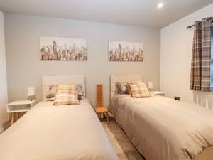 two beds in a small room with twoermottermott at The Steading in Dumfries +37 photos