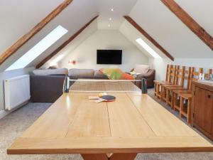a living room with a large wooden table at The Steading in Dumfries