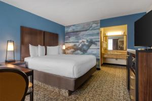 a hotel room with a bed and a flat screen tv at Best Western Winners Circle in Hot Springs +32 photos