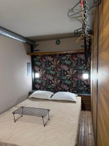a bedroom with two beds and a wall with a wallpaper at Swed Cab Embassy HoStel in Varna City