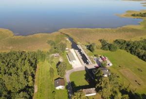 an aerial view of a river and a field with trees at Suurlahe Guesthouse in Kuressaare