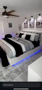 a bedroom with a large bed with a blue light at Love One in Midrand