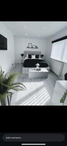 a bedroom with a bed and a table in it at Love One in Midrand