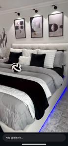 a bedroom with two beds with black and white pillows at Love One in Midrand