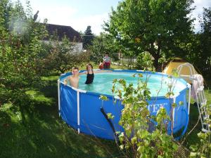 a man and a woman in a swimming pool at chalupa U Hovorků s bazénem - u pískoven Vlkov in Veselí nad Lužnicí