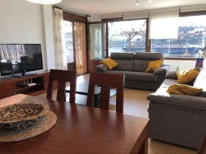 a living room with a couch and a table at Casa Rural La Guea de Teruel in Teruel
